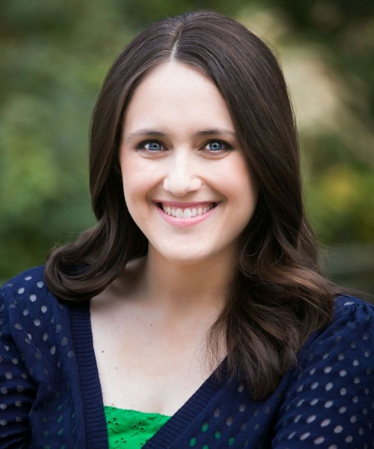 A professional headshot of #1 New York Times bestselling author Becky Albertalli, smiling warmly in a bright and friendly portrait.