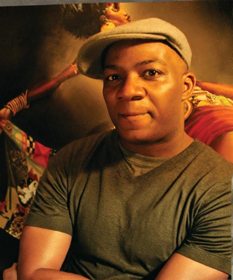 A professional headshot of award-winning illustrator Frank Morrison, smiling with a warm expression.