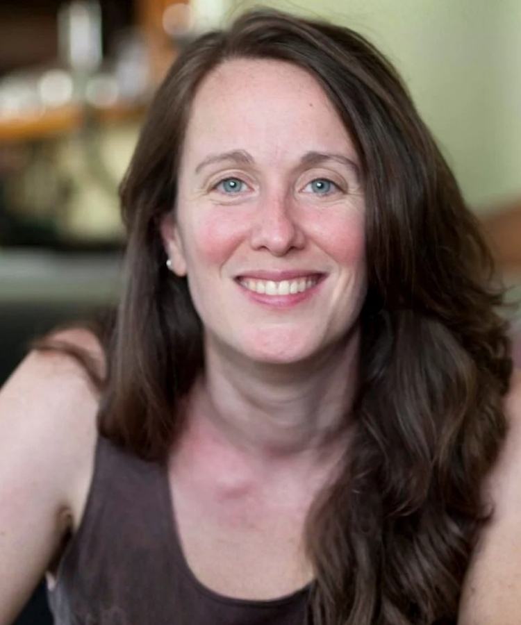 A professional headshot of Atlanta author Laurel Snyder, smiling warmly in a friendly and approachable portrait.