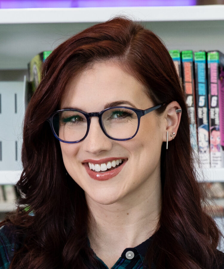 A professional headshot of author Lindsey Duga, smiling warmly in a friendly and professional portrait.