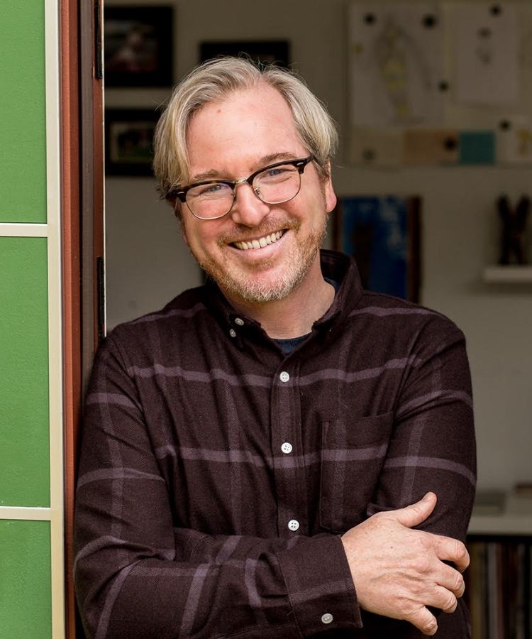 A professional headshot of award-winning author and illustrator Matt Phelan, smiling warmly in a professional and friendly portrait.